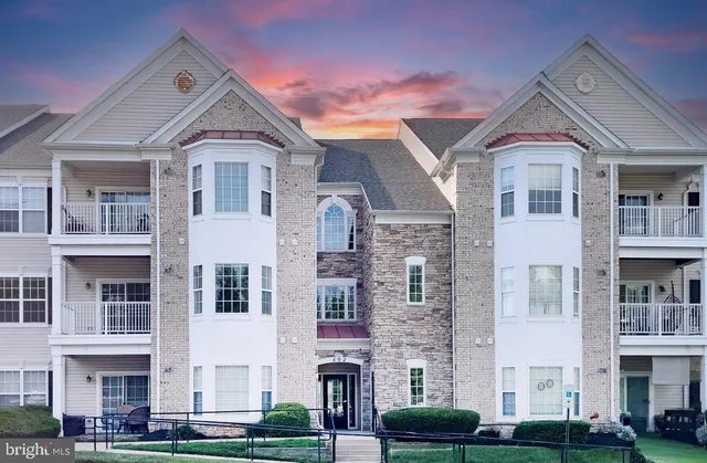 a front view of a residential houses with yard