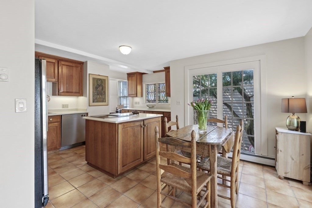 80 Front Street Marblehead, MA 01945 - Photo 11 of 42 a kitchen with stainless steel appliances granite countertop a stove a sink dishwasher and a refrigerator with wooden floor