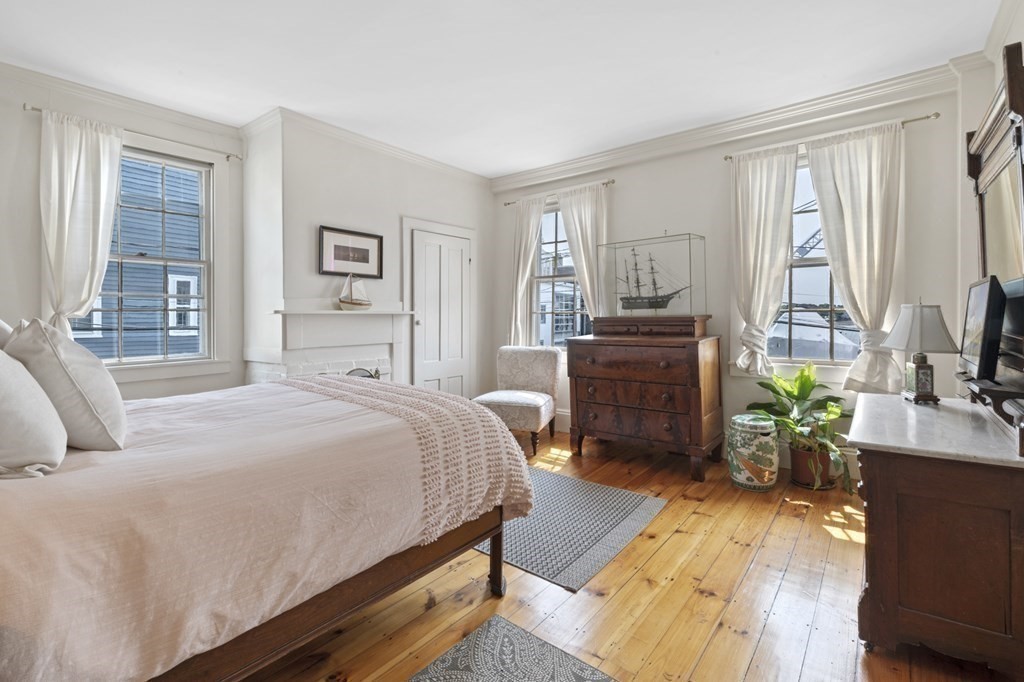 80 Front Street Marblehead, MA 01945 - Photo 27 of 42 a bedroom with a bed and wooden floor