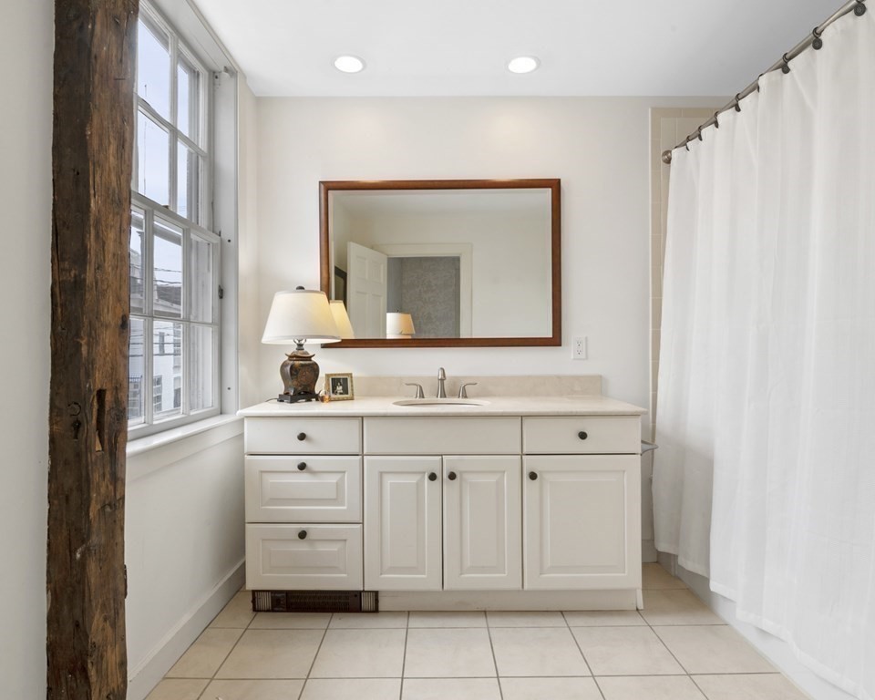 80 Front Street Marblehead, MA 01945 - Photo 30 of 42 a bathroom with a sink vanity and mirror