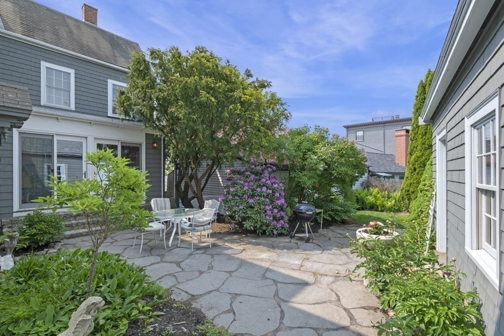 80 Front Street Marblehead, MA 01945 - Photo 9 of 42 a view of a chair and tables in the backyard of the house