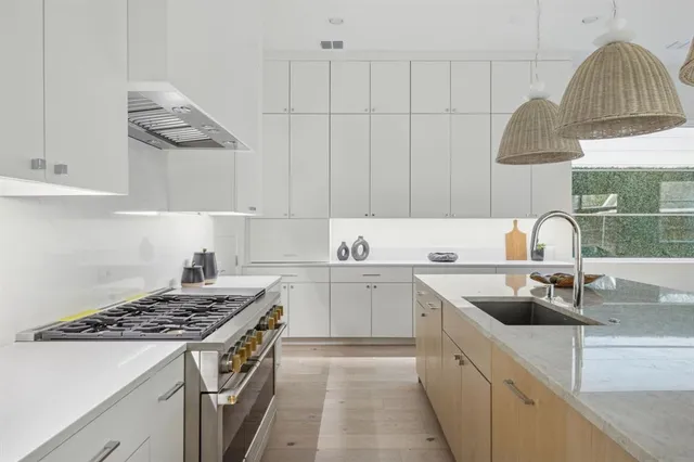 a kitchen that has a sink and a stove