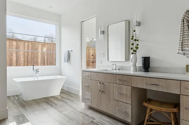 a bath room with a sink and a mirror