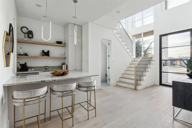 a kitchen with white cabinets and window