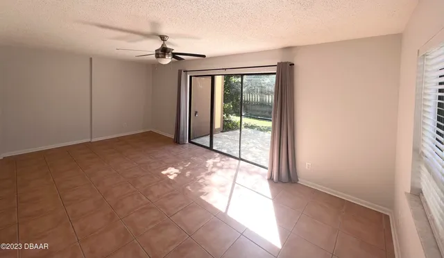 a view of a livingroom with a ceiling fan and window