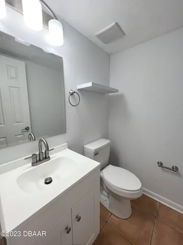 a white toilet sitting next to a bathroom sink