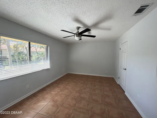 a view of a livingroom with a ceiling fan and window