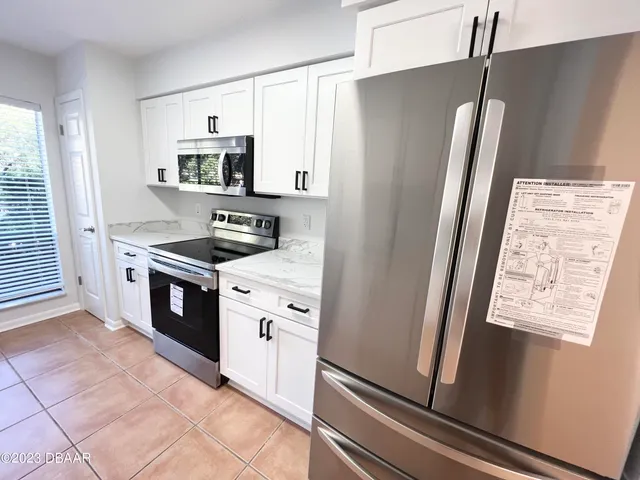 a kitchen with stainless steel appliances a refrigerator stove and sink