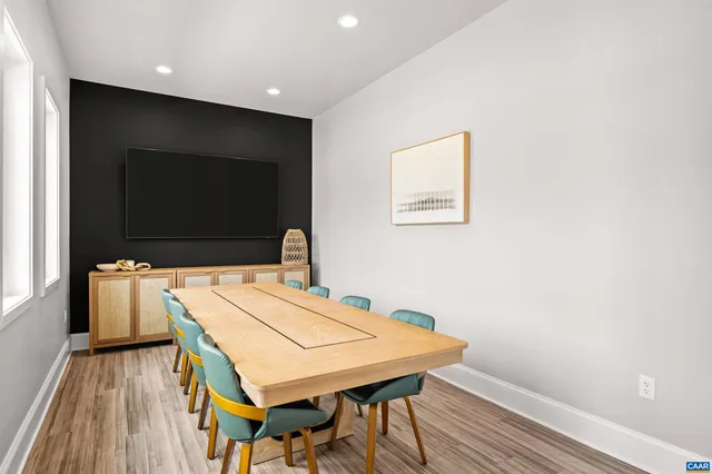 a kitchen with stainless steel appliances a microwave a stove a sink dishwasher and a refrigerator with wooden floor