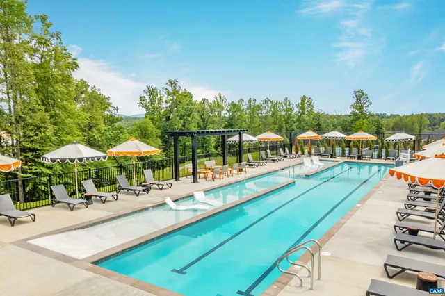 a view of a swimming pool with lawn chairs