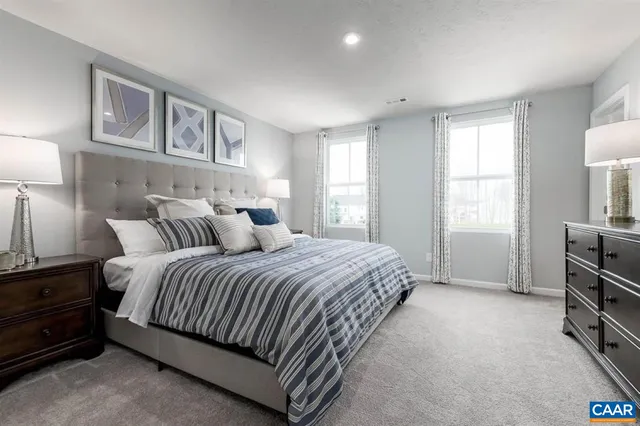 a spacious bedroom with a bed and a cabinets