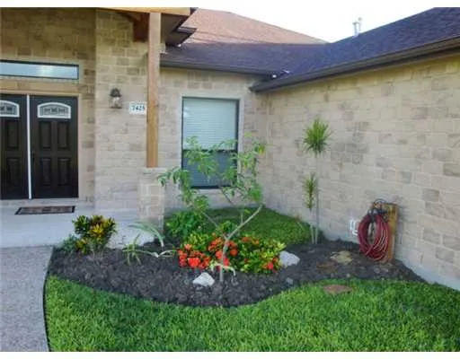 a view of a backyard with potted plants and a table