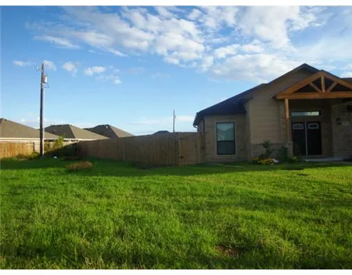 a view of a house with a backyard