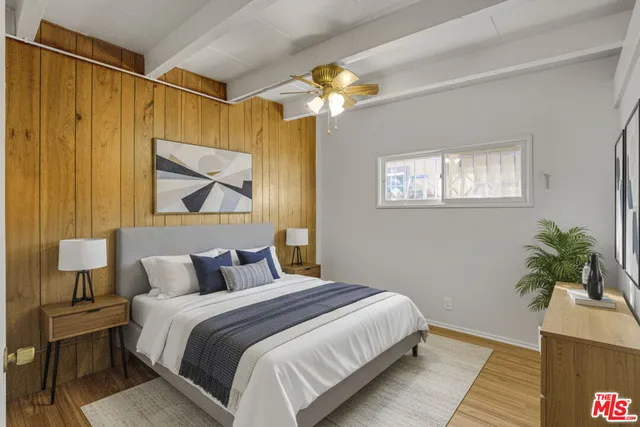 a bedroom with a bed and a potted plant