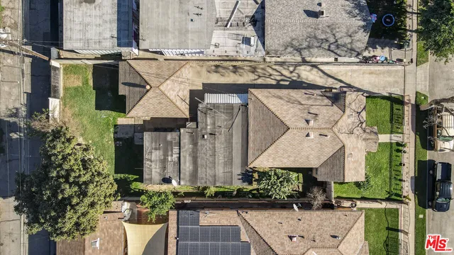 an aerial view of a house with large trees