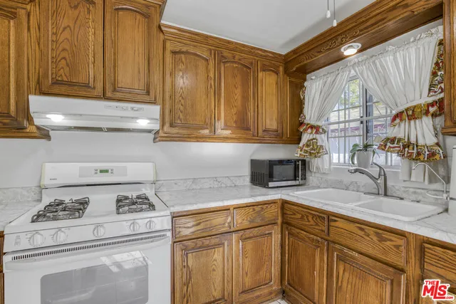a kitchen with appliances cabinets and a sink