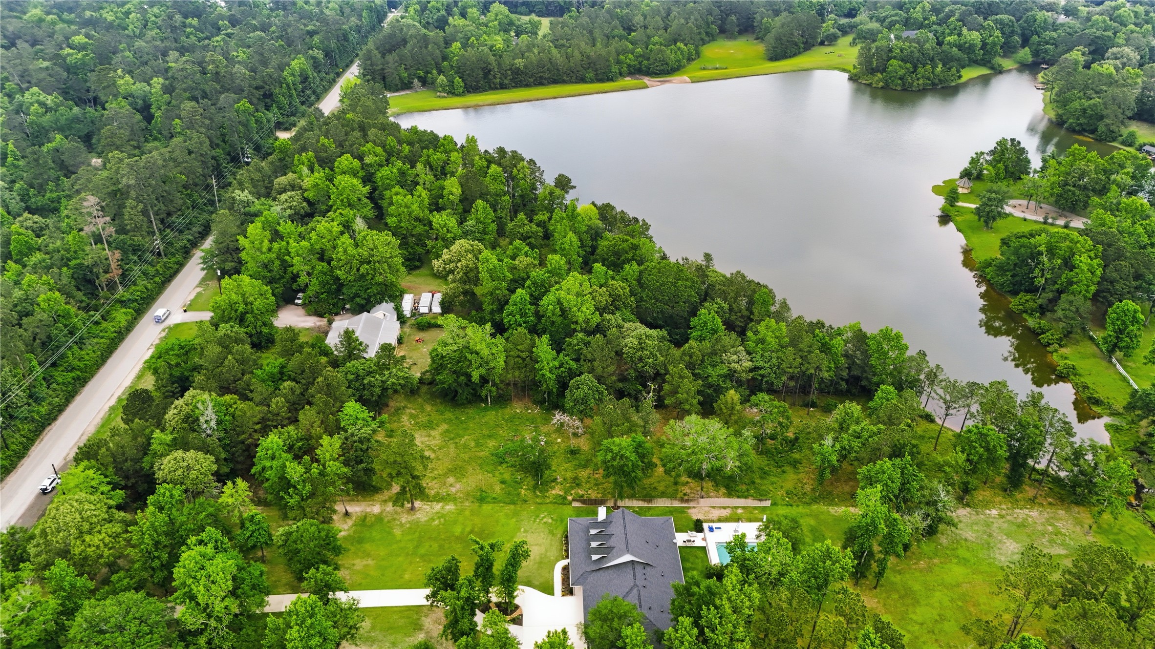 2302 Honea Egypt Road Magnolia, TX 77354 - Photo 12 of 12 an aerial view of a house with a yard and lake view