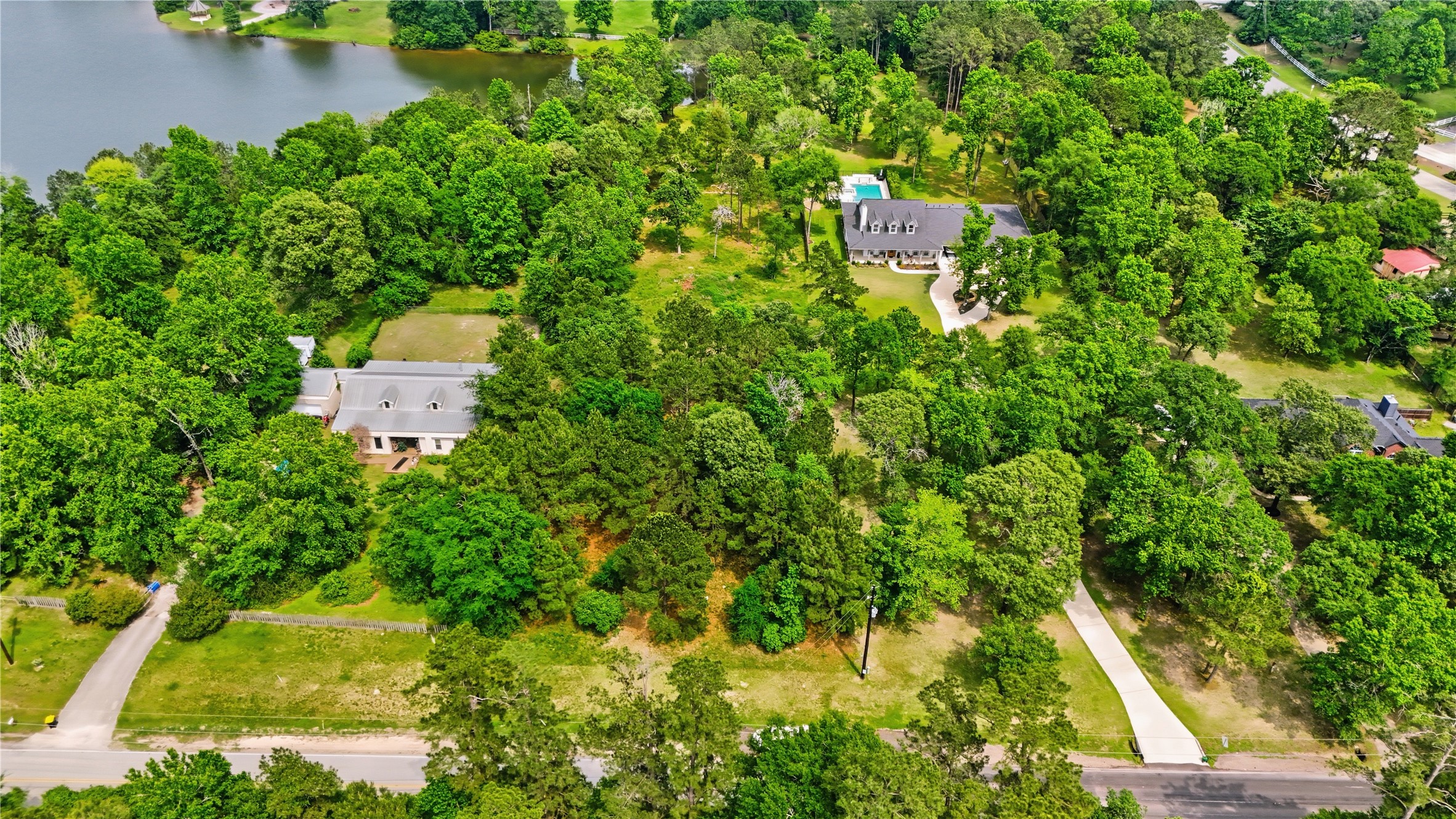 2302 Honea Egypt Road Magnolia, TX 77354 - Photo 8 of 12 an aerial view of residential house with outdoor space and trees all around
