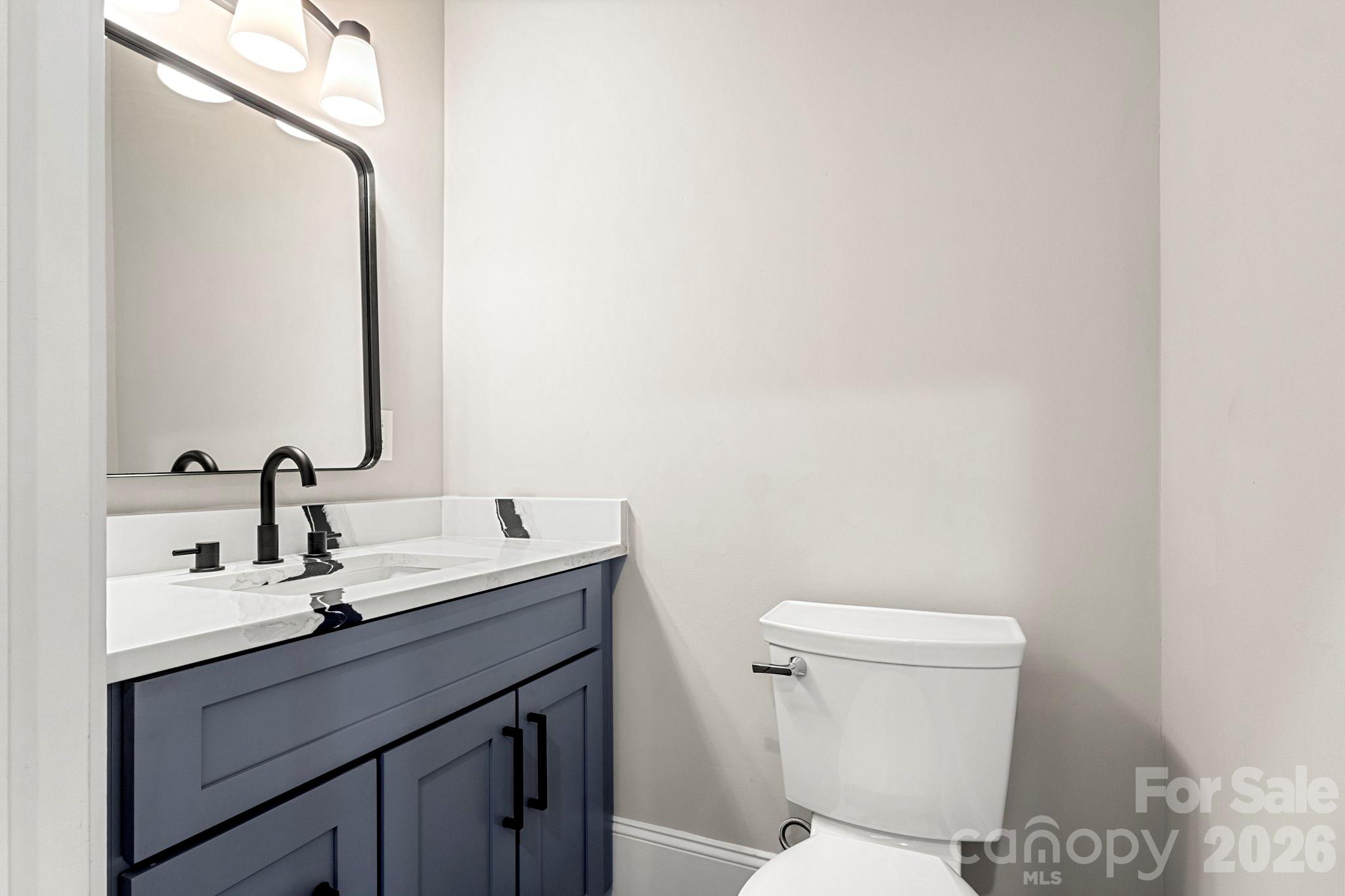 918 North New Hope Road Gastonia, NC 28054 - Photo 14 of 37 a bathroom with a toilet a sink and mirror