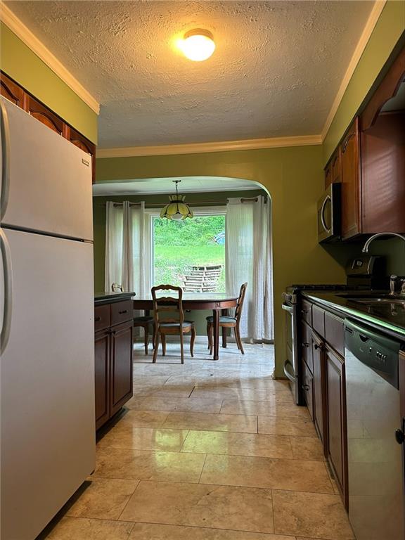 33 Union Avenue Pittsburgh, PA 15205 - Photo 6 of 32 a kitchen with stainless steel appliances granite countertop a refrigerator a stove a sink a dining table and chairs with wooden floor
