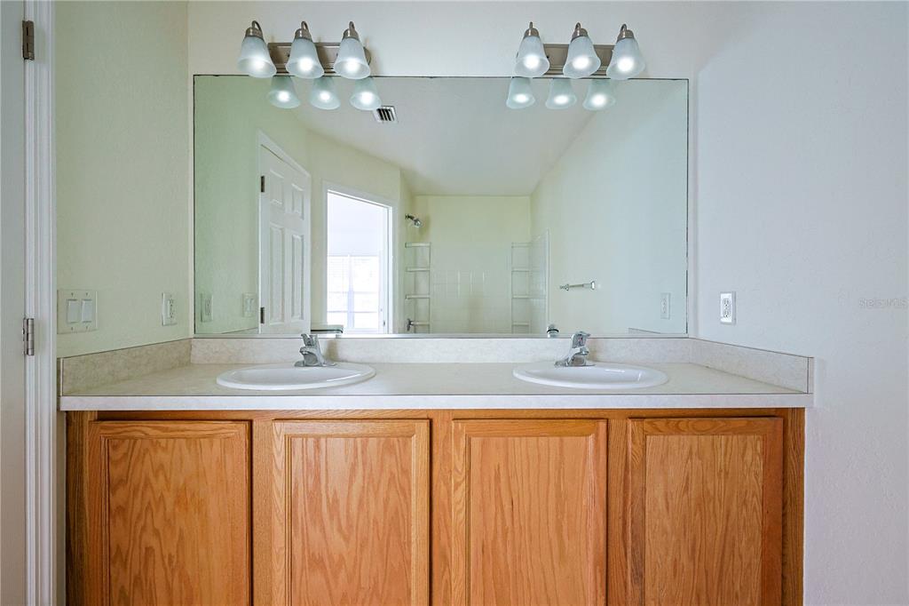 4116 Southwest 54th Circle Ocala, FL 34474 - Photo 16 of 36 a bathroom with a granite countertop sink and a mirror