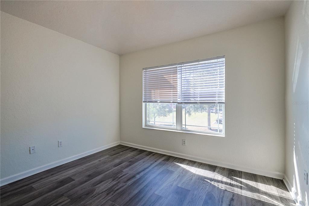 4116 Southwest 54th Circle Ocala, FL 34474 - Photo 25 of 36 an empty room with wooden floor and windows