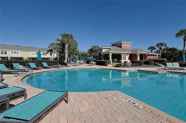 a view of a swimming pool with chairs