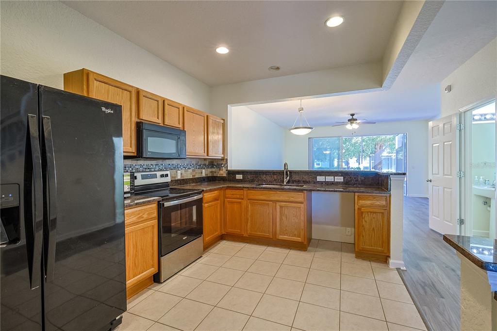 4116 Southwest 54th Circle Ocala, FL 34474 - Photo 4 of 36 a kitchen with stainless steel appliances granite countertop a refrigerator and a sink