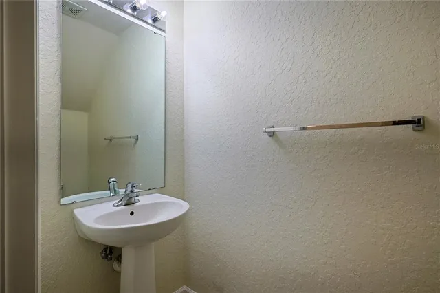 a bathroom with a sink a mirror and shower