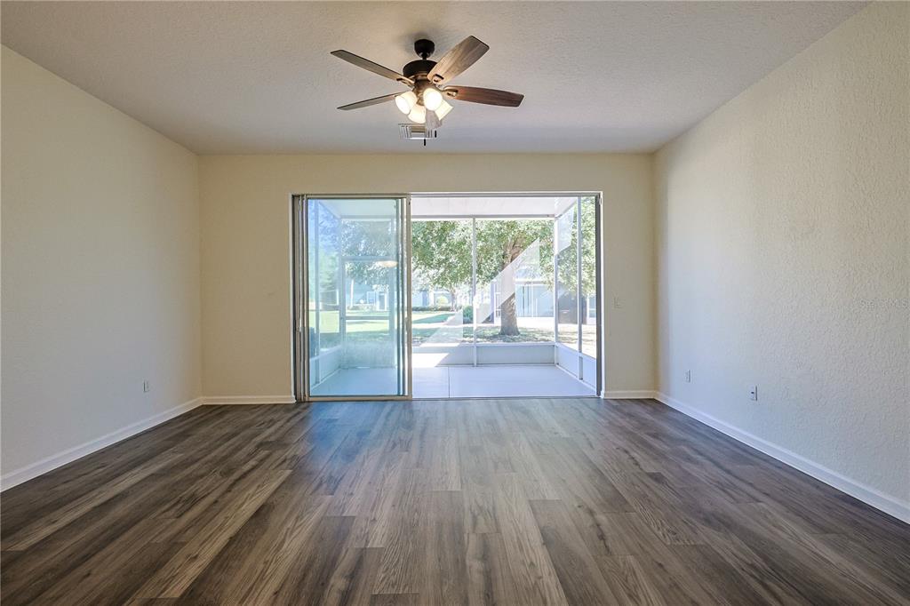 4116 Southwest 54th Circle Ocala, FL 34474 - Photo 9 of 36 a view of empty room with wooden floor and fan