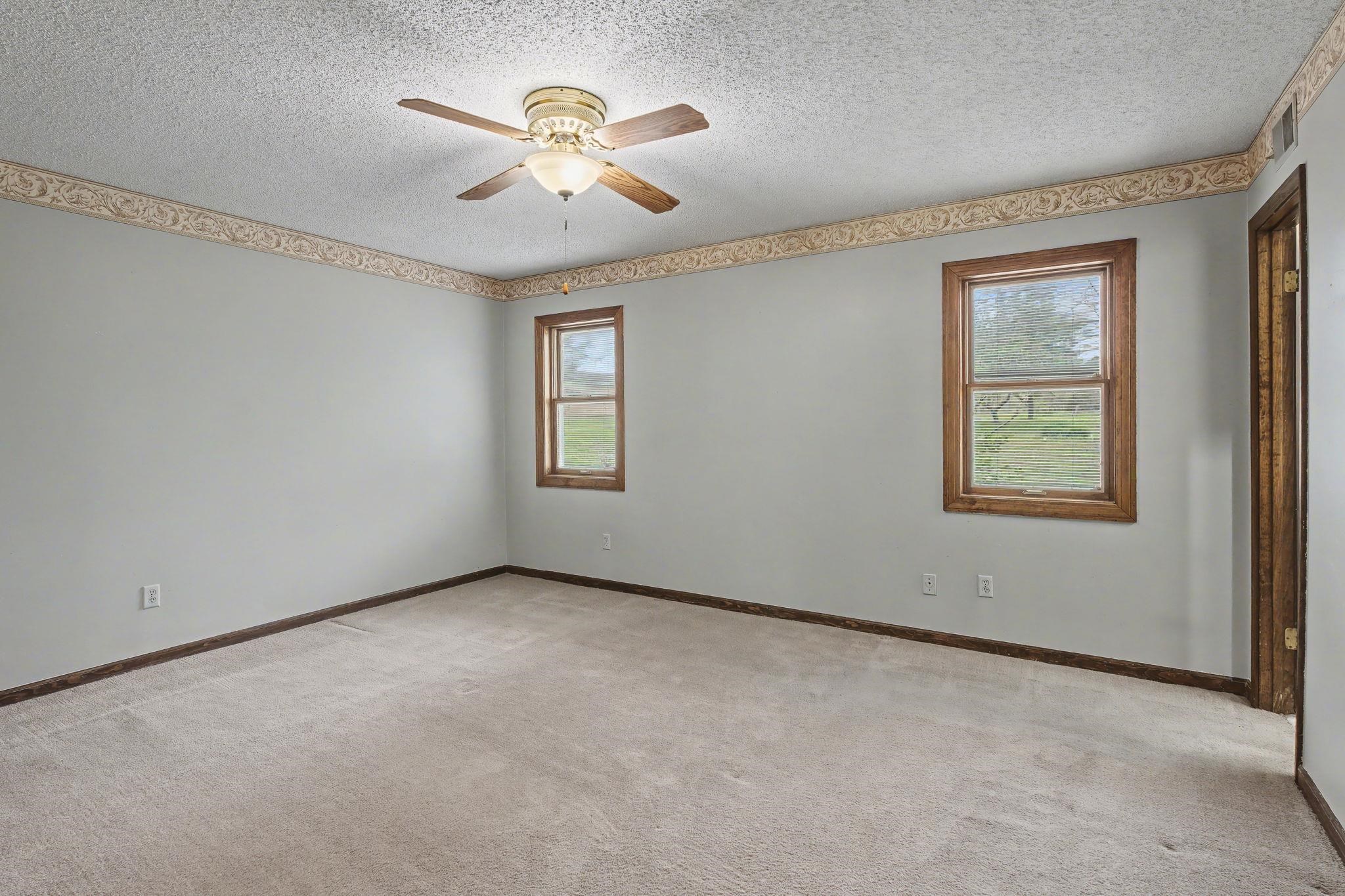 11380 Sycamore Farms Road Collierville, TN 38017 - Photo 21 of 35 Spare room featuring light colored carpet, ceiling fan, and a textured ceiling