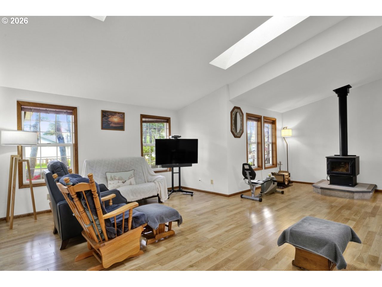 1960 40th Street Florence, OR 97439 - Photo 11 of 48 a living room with furniture a flat screen tv and a large window