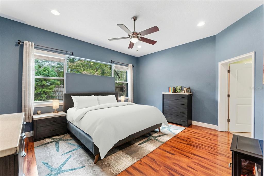 5130 Morning Dew Loop Oviedo, FL 32765 - Photo 15 of 38 a bedroom with a bed and a chandelier