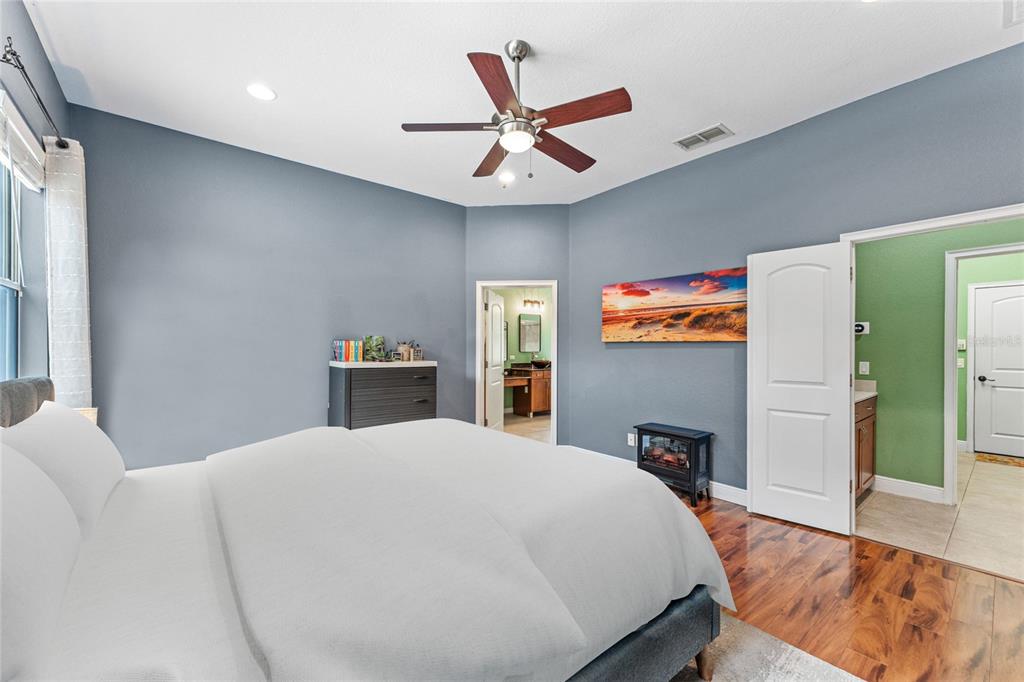 5130 Morning Dew Loop Oviedo, FL 32765 - Photo 16 of 38 a bed room with a bed and a chandelier