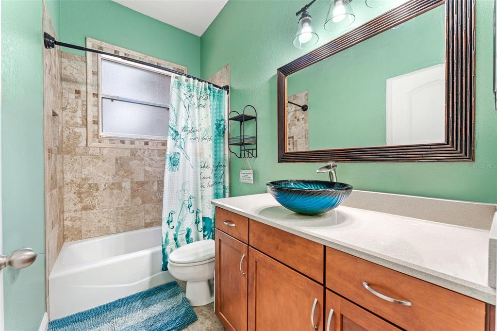 5130 Morning Dew Loop Oviedo, FL 32765 - Photo 22 of 38 a bathroom with a granite countertop sink a toilet and bathtub