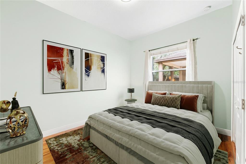 5130 Morning Dew Loop Oviedo, FL 32765 - Photo 23 of 38 a bedroom with a bed and wooden floor