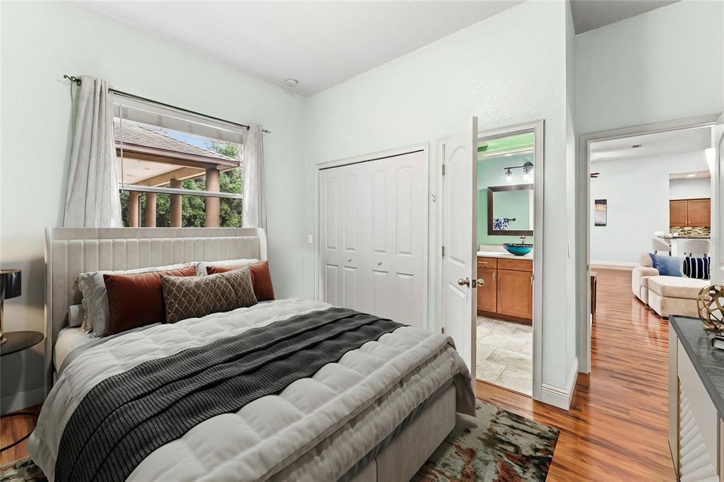 5130 Morning Dew Loop Oviedo, FL 32765 - Photo 24 of 38 a bedroom with a bed and wooden floor