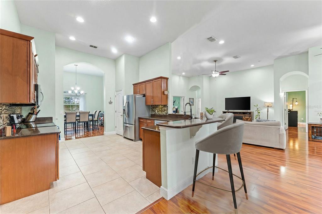5130 Morning Dew Loop Oviedo, FL 32765 - Photo 10 of 38 a kitchen with stainless steel appliances kitchen island granite countertop a sink and cabinets