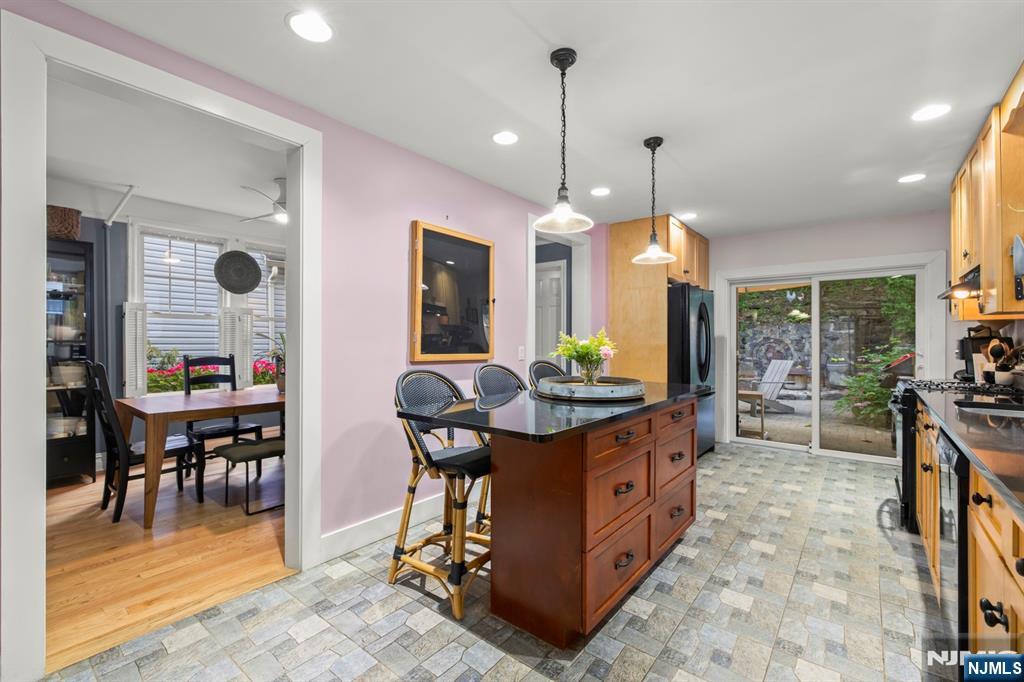 370 Undercliff Avenue Edgewater, NJ 07020 - Photo 12 of 35 a kitchen with stainless steel appliances granite countertop a stove a sink a dining table and chairs