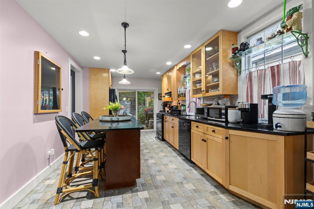 370 Undercliff Avenue Edgewater, NJ 07020 - Photo 13 of 35 a kitchen with stainless steel appliances granite countertop a sink a stove and a refrigerator