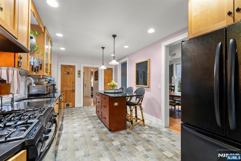 370 Undercliff Avenue Edgewater, NJ 07020 - Photo 15 of 35 a kitchen with stainless steel appliances granite countertop a refrigerator stove and a sink