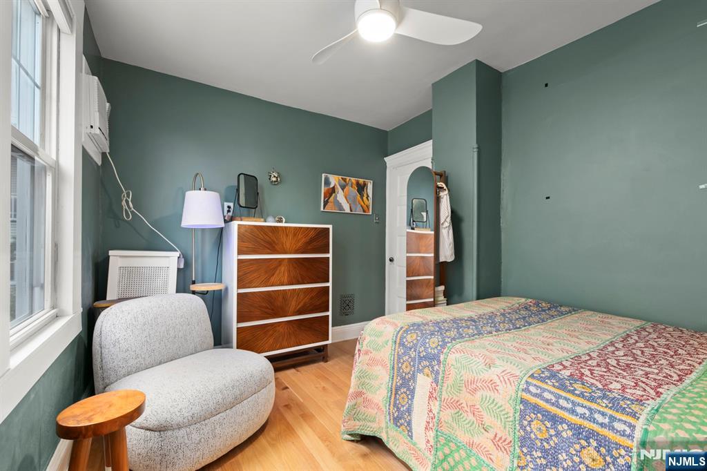 370 Undercliff Avenue Edgewater, NJ 07020 - Photo 24 of 35 a bedroom with a bed and furniture
