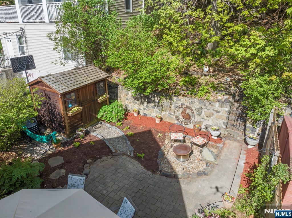 370 Undercliff Avenue Edgewater, NJ 07020 - Photo 31 of 35 a view of a patio with table and chairs and potted plants