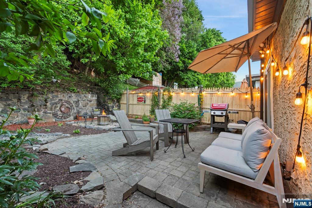 370 Undercliff Avenue Edgewater, NJ 07020 - Photo 33 of 35 a view of patio with couches and table under an umbrella