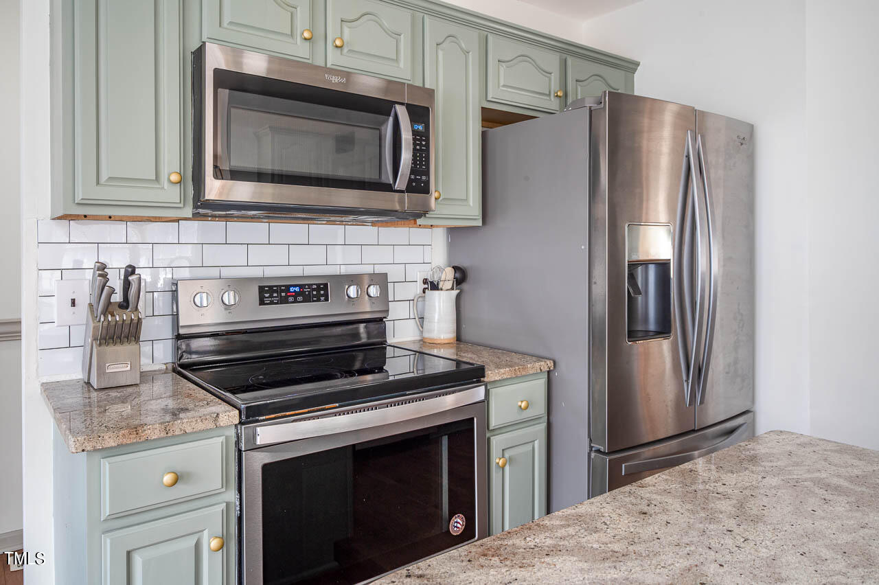 4552 Springbrook Drive Burlington, NC 27215 - Photo 13 of 57 a kitchen with granite countertop cabinets and steel stainless steel appliances