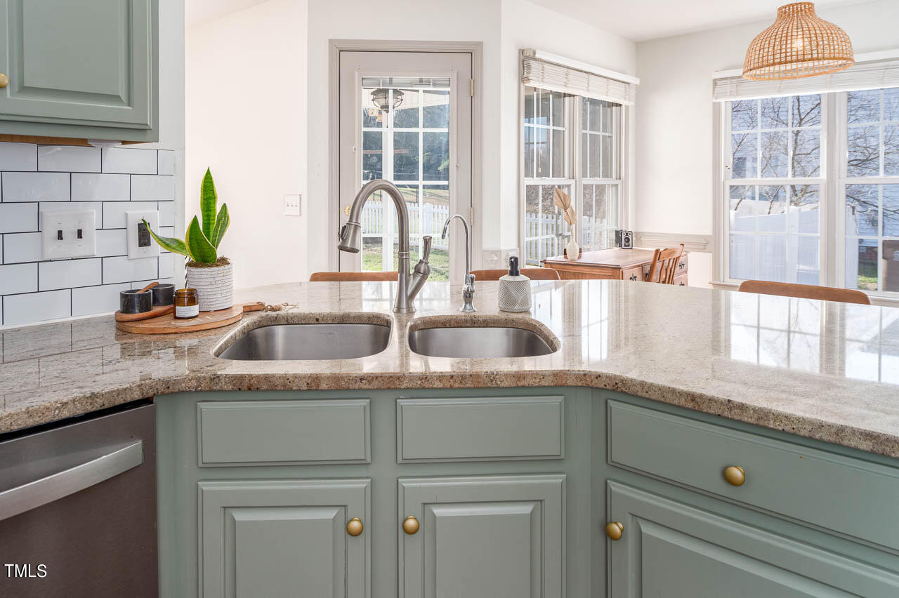 4552 Springbrook Drive Burlington, NC 27215 - Photo 14 of 57 a kitchen with granite countertop a sink and a window