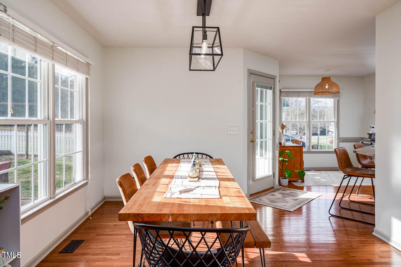 4552 Springbrook Drive Burlington, NC 27215 - Photo 18 of 57 a view of a dining room with furniture window and wooden floor
