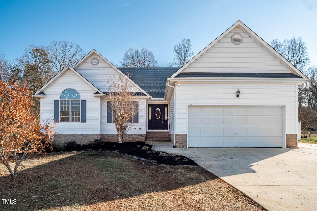 4552 Springbrook Drive Burlington, NC 27215 - Photo 2 of 57 a view of a white house with a yard and large parking space