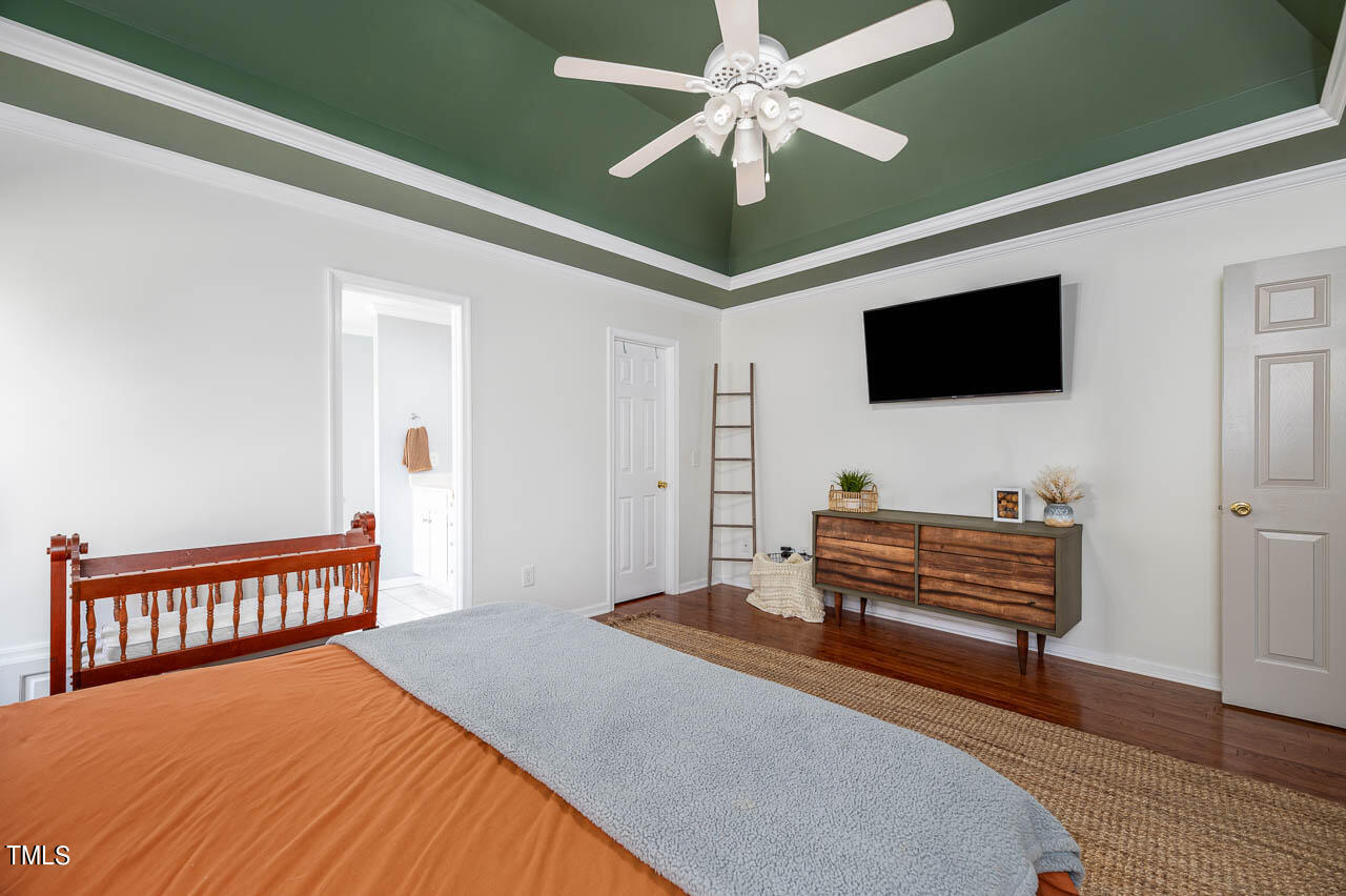 4552 Springbrook Drive Burlington, NC 27215 - Photo 22 of 57 a bedroom with furniture and a flat screen tv