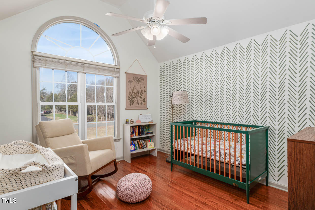 4552 Springbrook Drive Burlington, NC 27215 - Photo 24 of 57 a view of a bedroom with furniture and wooden floor